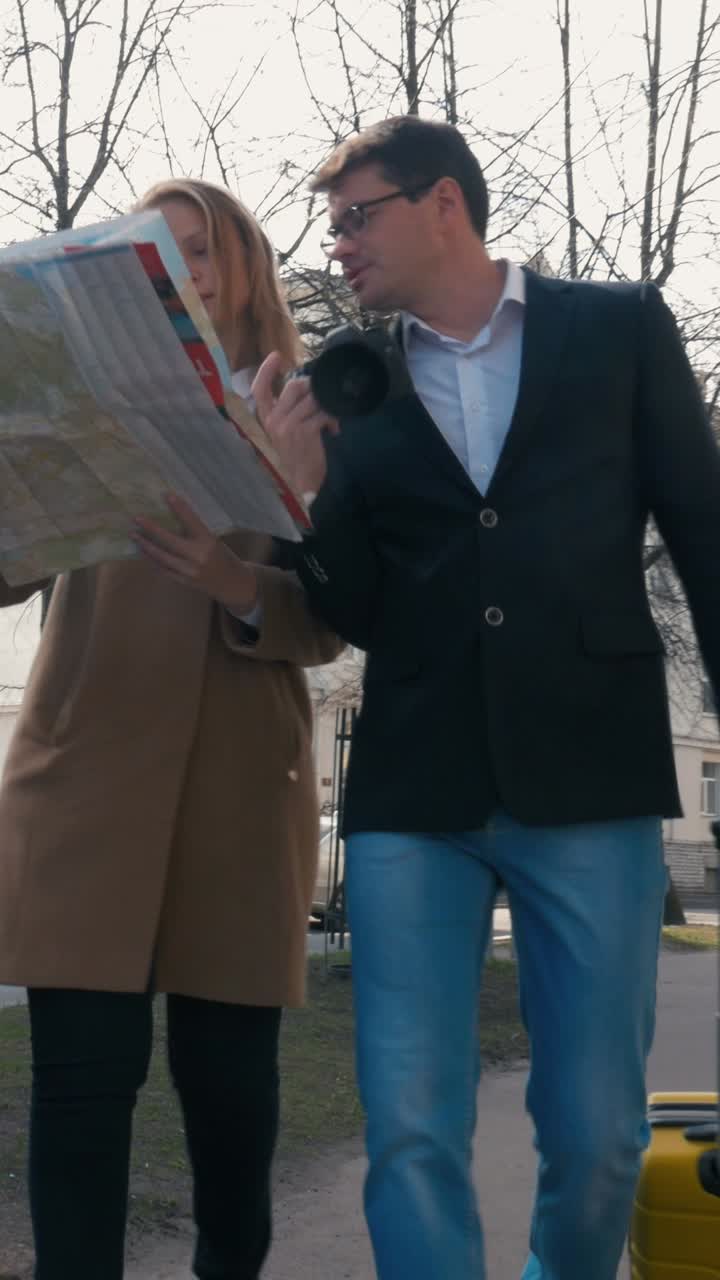 Couple traveling with a map and camera