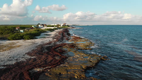 Drone-flight-over-beach-with-crashing-waves-near-Playa-del-Carmen,-Mexico