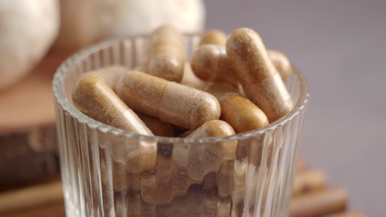 Brown Herbal Supplement Capsules in a Glass Container