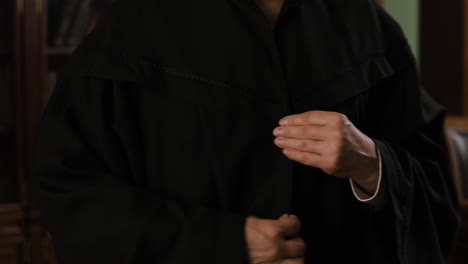 senior woman in formal robe in a library
