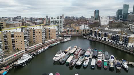 Apartments-and-boats-moored-Limehouse-basin-East-London-pull-back-Drone,-Aerial,-reveal-view