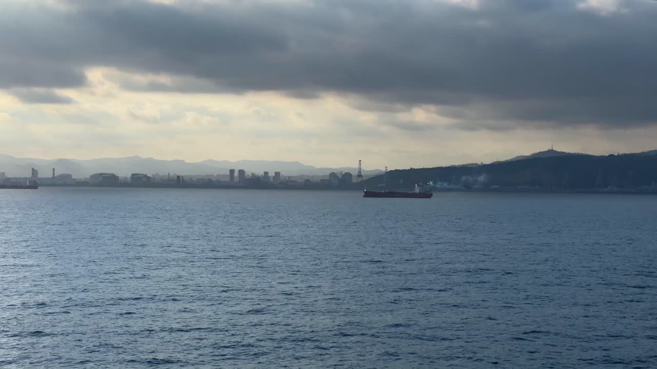 Barcelona commercial port cargo ship cranes in the background