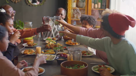 african american family toasting at home holiday dinner