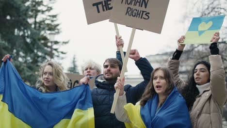 group of young caucasian people manifesting against ukrainian war.