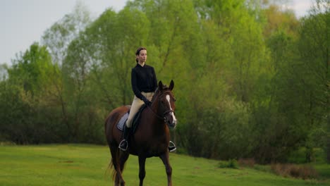 woman horseback riding in a park
