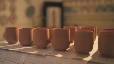clay pots getting dried under sunlight during daytime in pakistan.