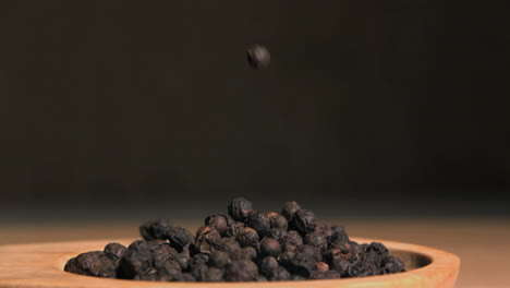 black peppercorns falling in super slow motion