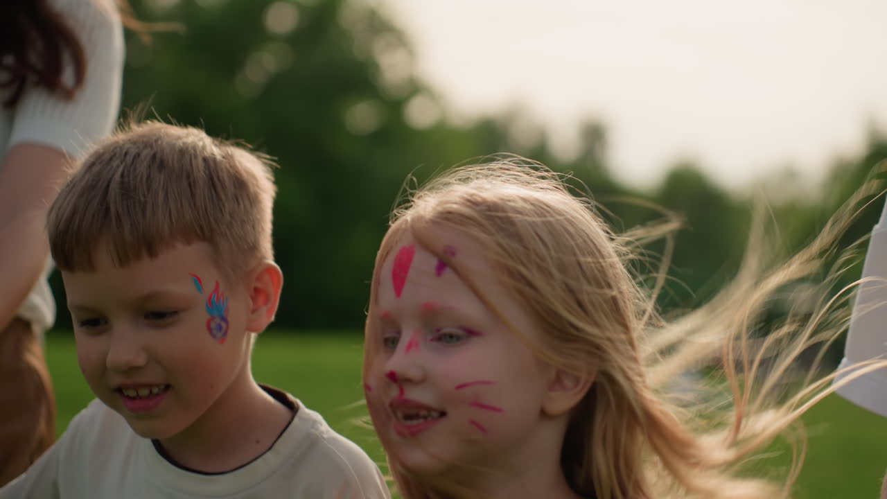 face painted children holding hands with parents walking through park, looking around with excitement, smiling, enjoying sunny afternoon, family bonding, curious glances at green surroundings