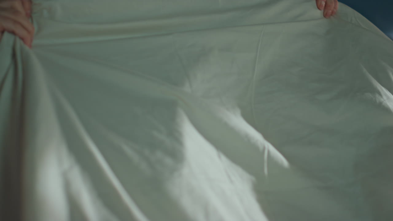 Portrait relaxed girl waking up in bedroom looking camera. Happy woman lying bed