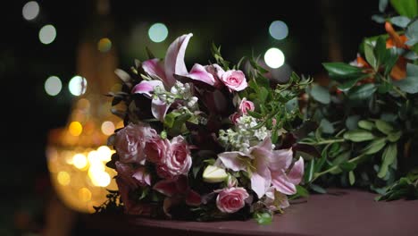 wedding bouquet with flowers of lilies and roses lies on a table