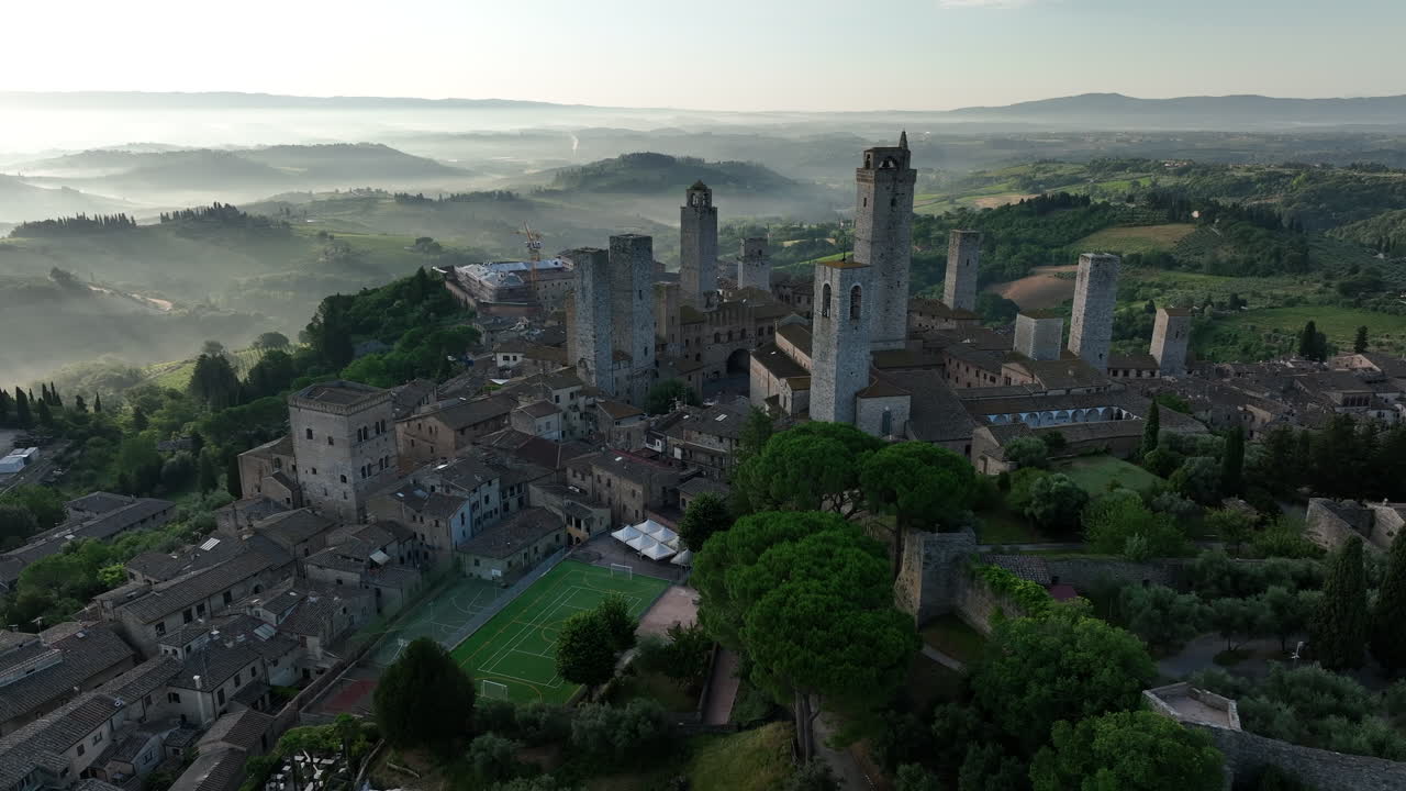 Sunrise overlooking the town of San Gimignano Tuscany in Italy with morning fog