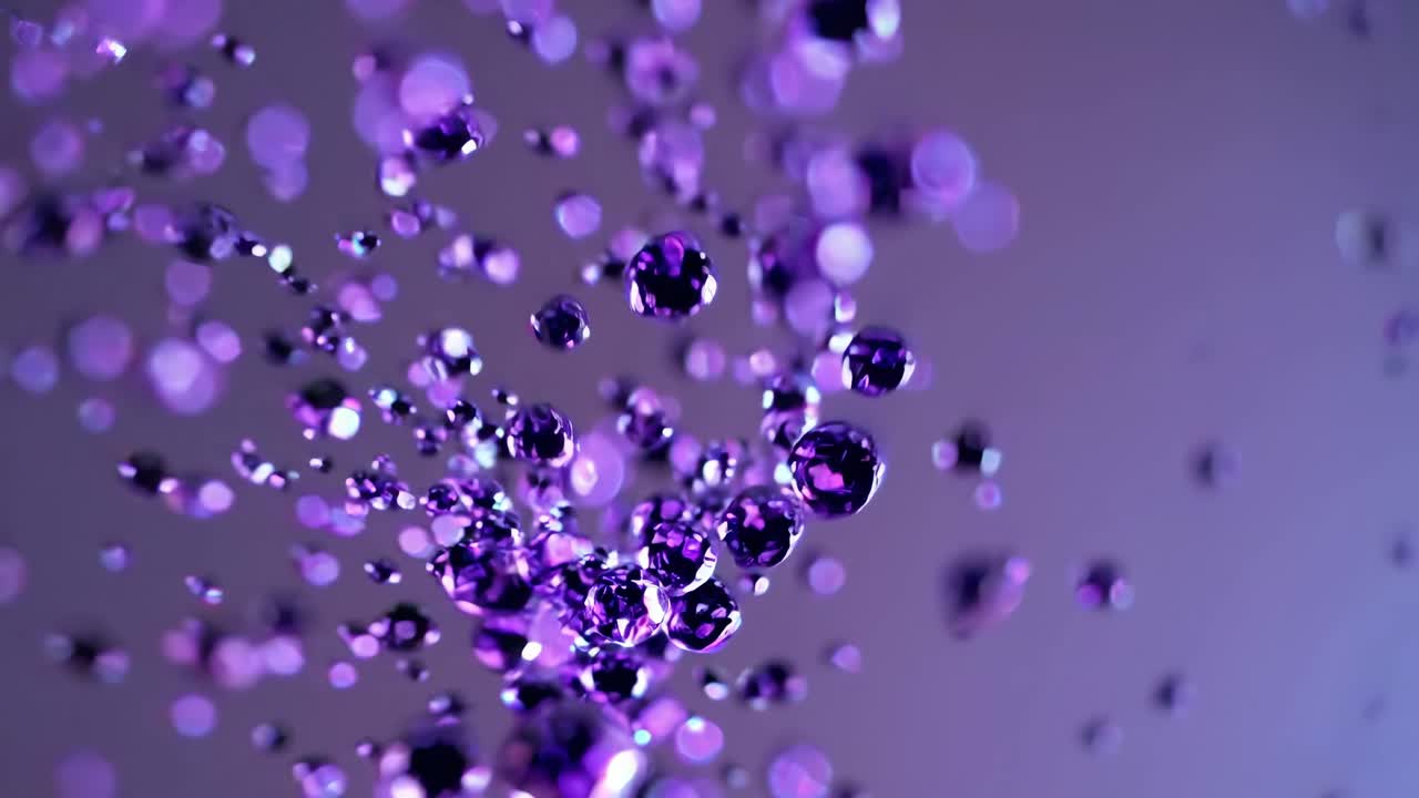 Close-up video of purple droplets suspended in mid-air, captured with a macro lens