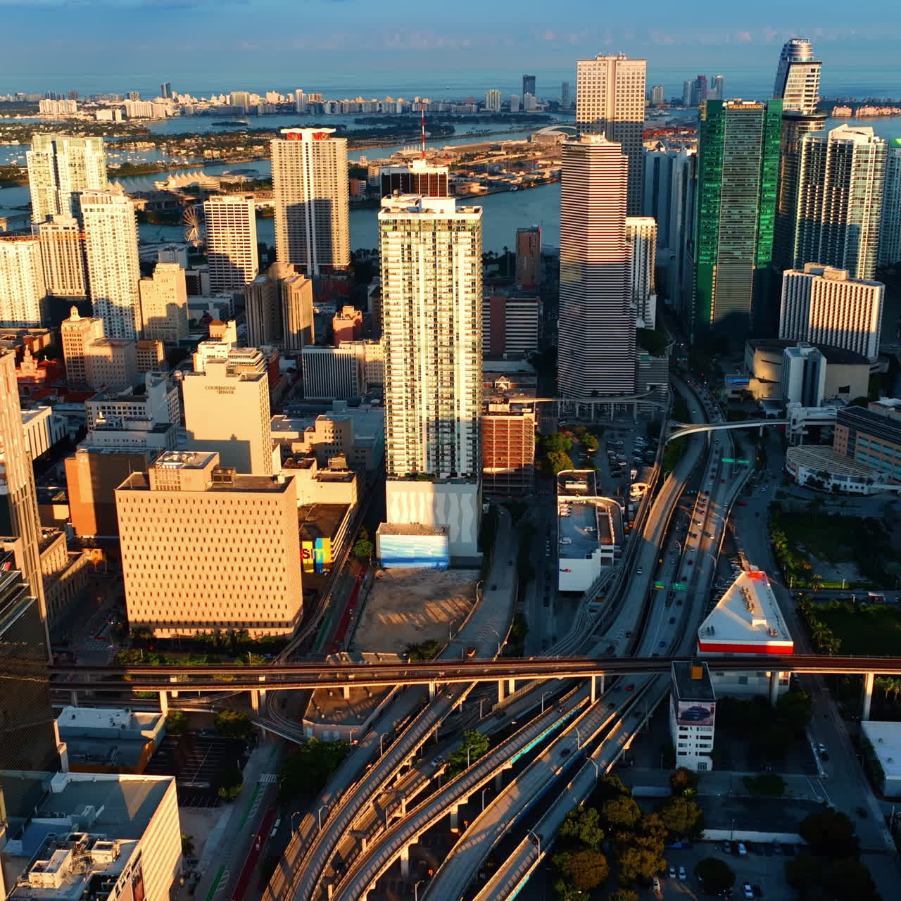 High-rise buildings in the bright rays of sun at sunset. Magnificent view of Miami, Florida, USA from top perspective.