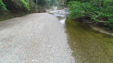 Gimbal-walk-forward-over-bed-of-Dajabon-river,-Dominican-Republic
