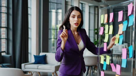 professional woman brainstorming with sticky notes in a modern office