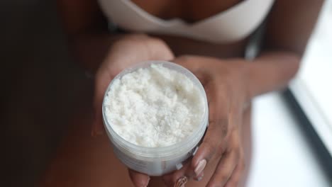 woman applying body scrub