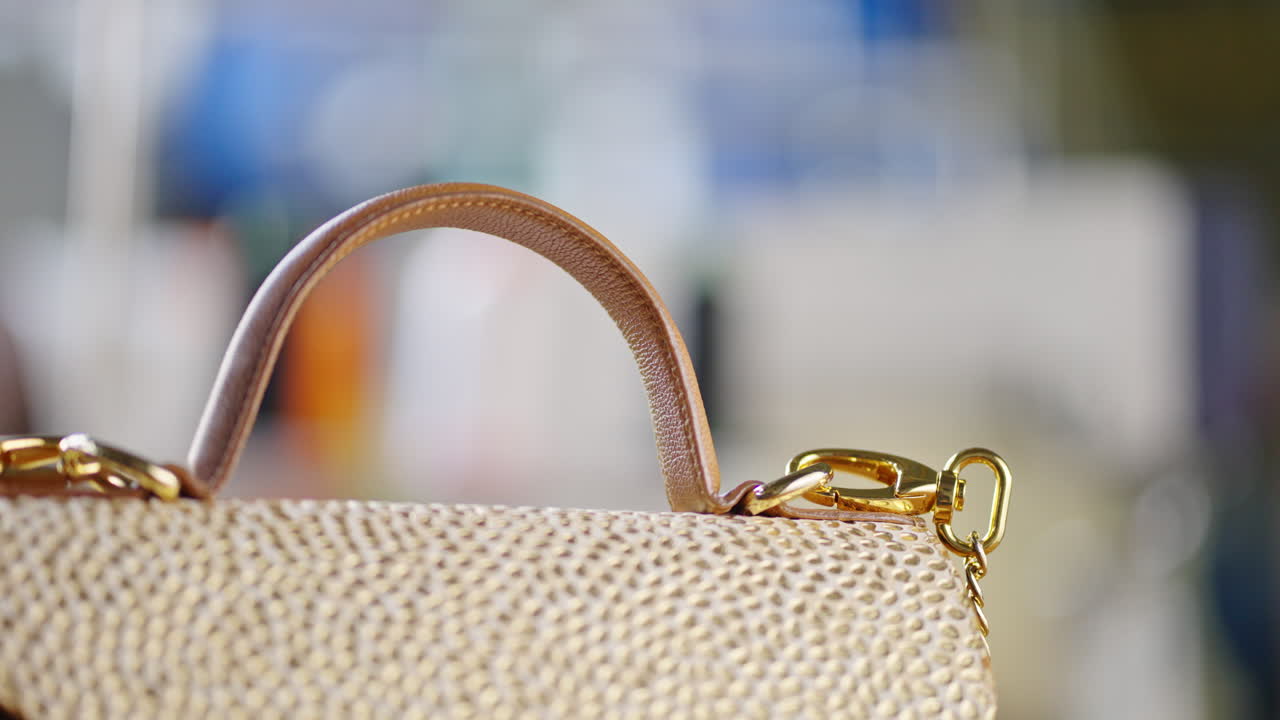 Close-up of a stylish gold handbag