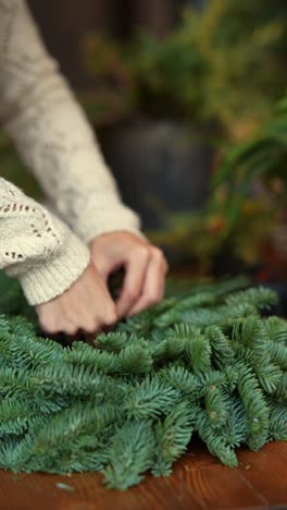 woman making a christmas wreath