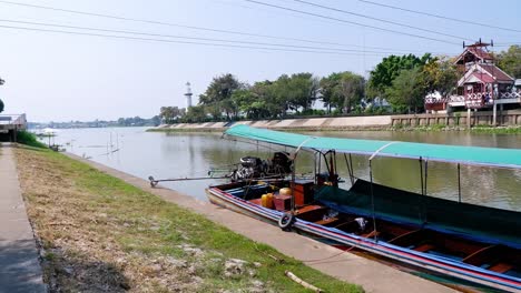 a long boat travels along a river