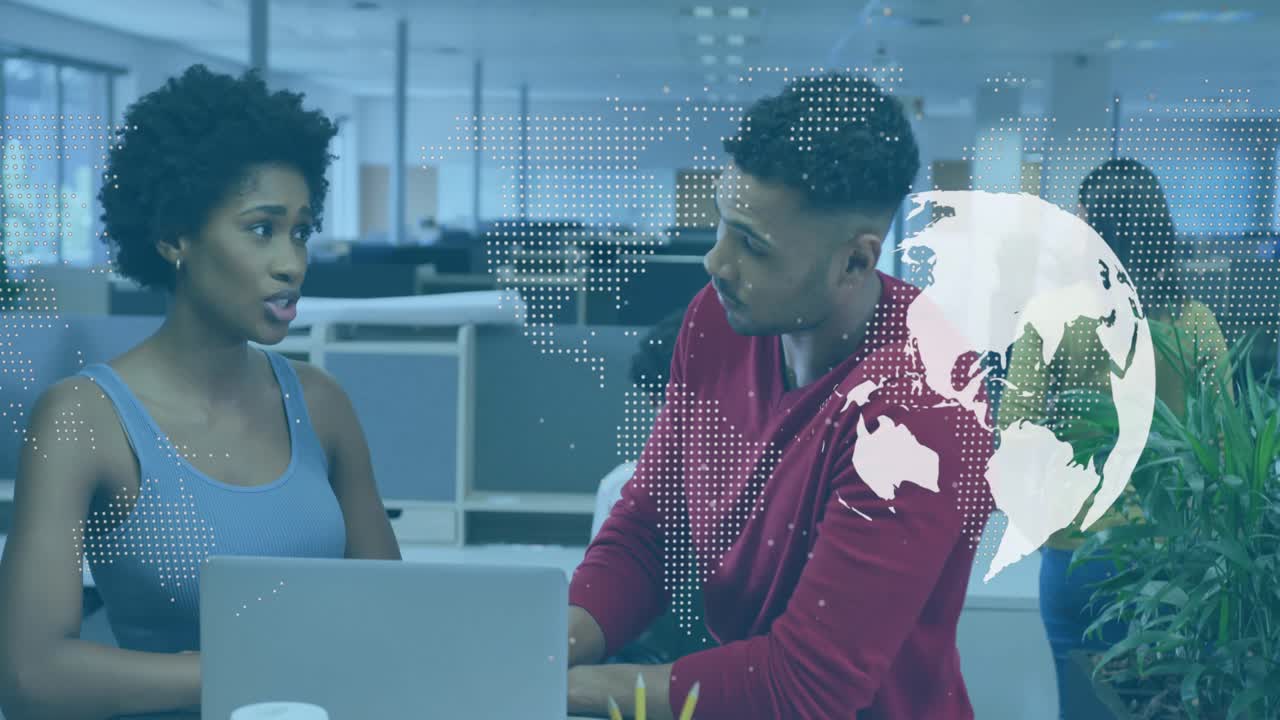 Woman pointing laptop keyboard starting business chat, man leaning taking notes with globe overlay