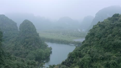 aerial drone shot push through the mountians in asia