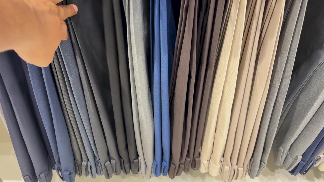 Hand Selecting paint Fabric From Textile Display At retail Showroom