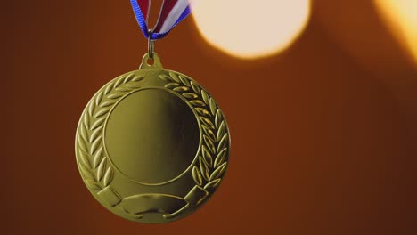 gold medal on orange background