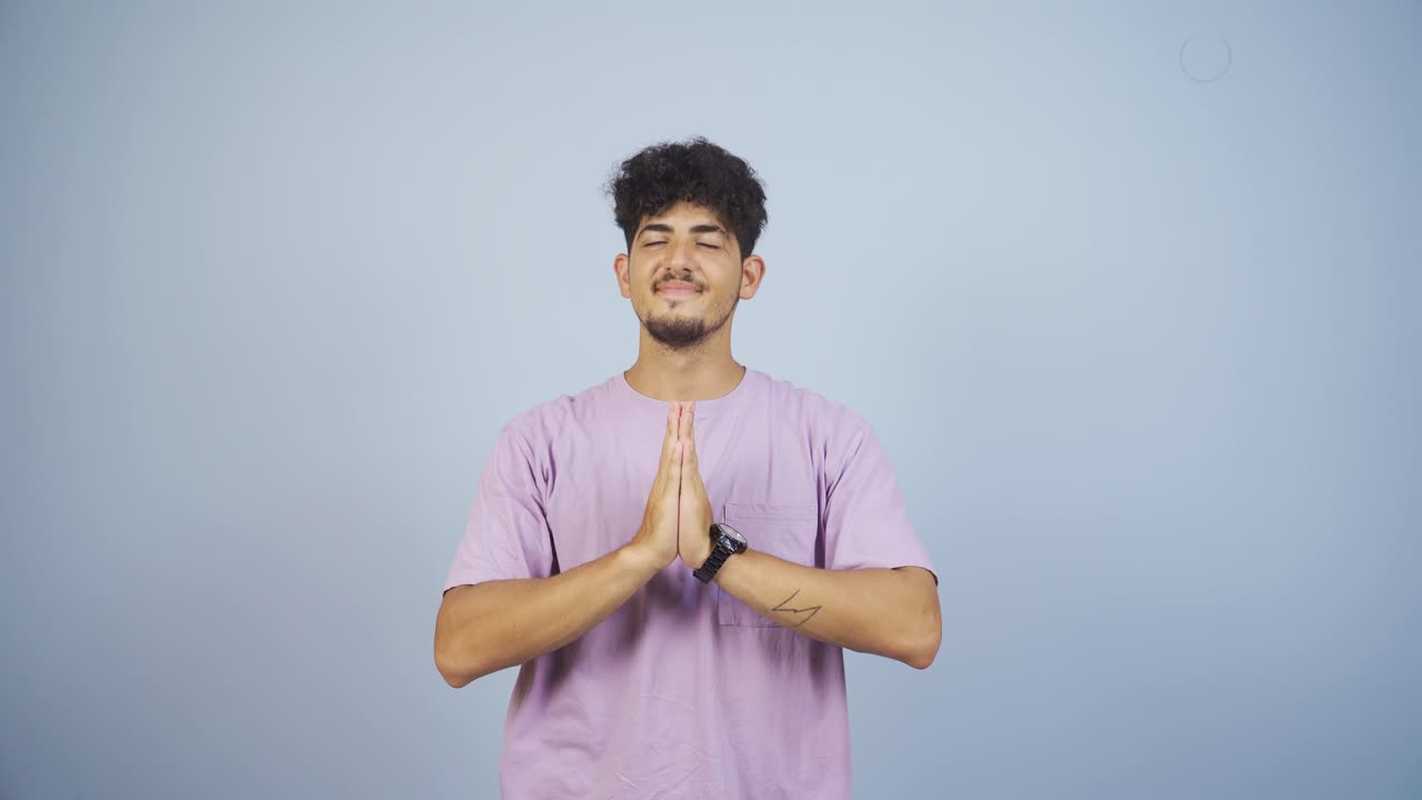 Man meditating looking at camera.