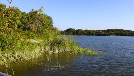 People-kayaking-at-a-distance-on-Cedar-Lake-in-Cleburne-State-Park-in-Texas