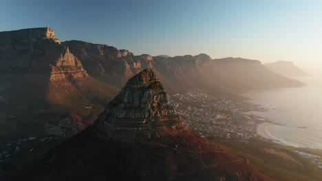 lion's head mountain at signal hill with camps bay suburb at sunrise in cape town, south africa