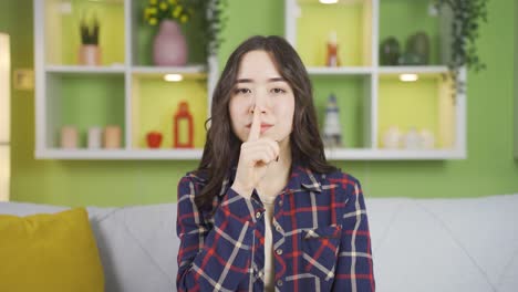 Asian-teenager-looking-serious-and-sharp-at-the-camera-says-shut-up.