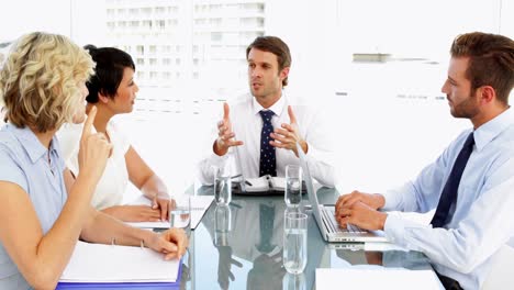 Business-people-listening-to-their-boss-during-meeting