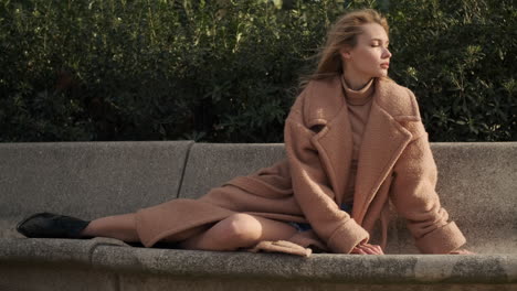 young woman lying on bench in the park.