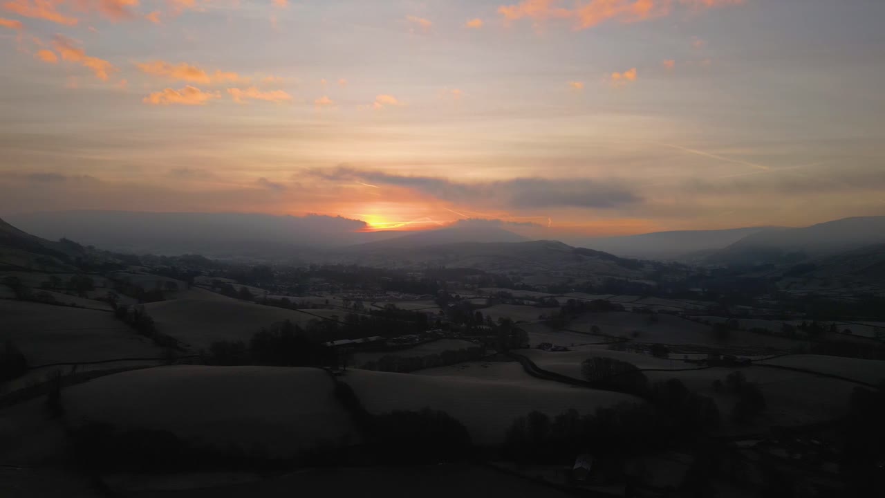 Stunning Drone footage of sunrise in the Yorkshire Dales above the village of Sedbergh. Dawn sunrise above the hills and misty landscape of the Yorkshire dales national Park.