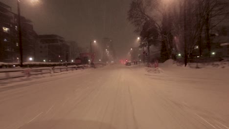 pov driving shot through a snowstorm in downtown helsinki