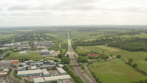 Circling-aerial-shot-of-raised-interchange-over-A1-Motorway-Stevenage-UK