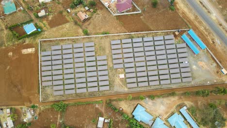 jib down of solar panel farm in rural africa- sdg green renewal energy- solar panel cell photovoltaic farm