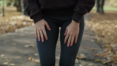 ginger woman warming up before running at the park in autumn