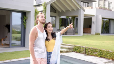 A-diverse-couple-relaxing-by-pool-with-a-blue-background