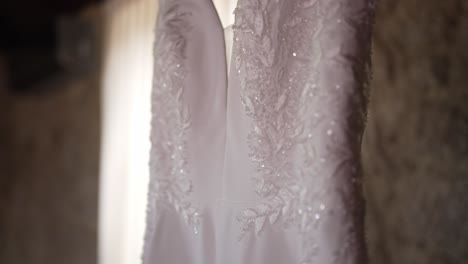 close up of wedding dress detailing, highlighting intricate lace and delicate beadwork