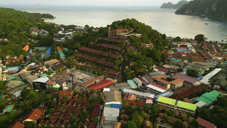 aerial drone shot flying toward the phi phi rim khao hotel in thailand