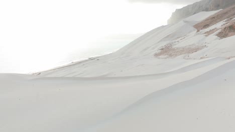 Aerial-rising-shot-of-Socotra-white-sand-dunes-or-archer-beach-during-sunrise-in-Yemen