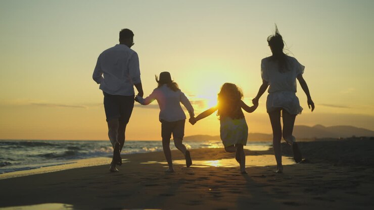 Family Running on Beach at Sunset