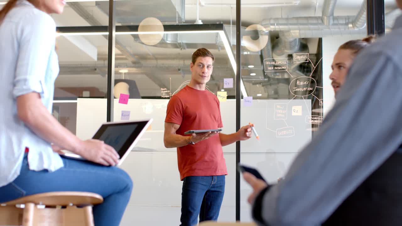 feliz hombre de negocios caucásico casual presentando a diversos colegas en la pared de vidrio, cámara lenta