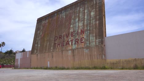 establishing shot of an abandoned drive in movie theater 1