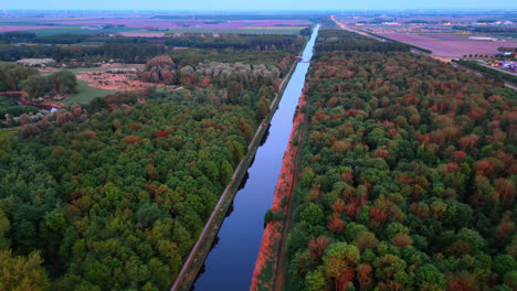 peaceful canal in dutch nature. a calm canal winds through lush greenery, mirroring nature's colors in the scenic netherlands