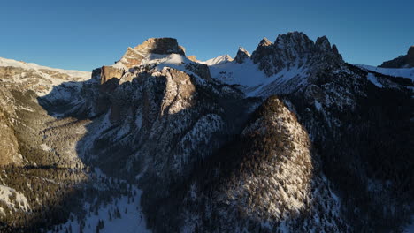 snow covered mountain range with blue sky in selva di val gardena, italy