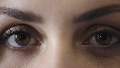 close up of woman eyes opening looking at camera wearing makeup cosmetics