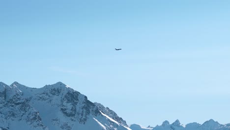 private jet flying over the snow covered mountain peaks during winter in st