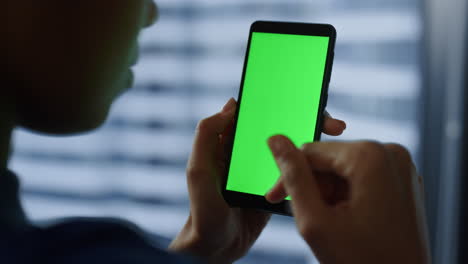 Businesswoman-using-mobile-phone-with-green-screen.-Woman-chatting-on-cellphone